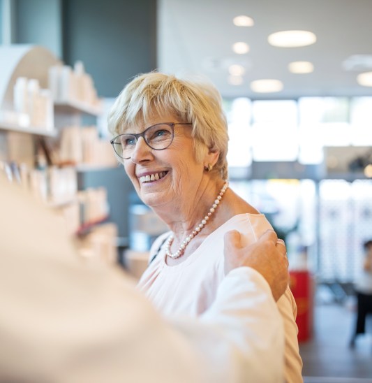 HCP patients smiling senior customer at pharmacy